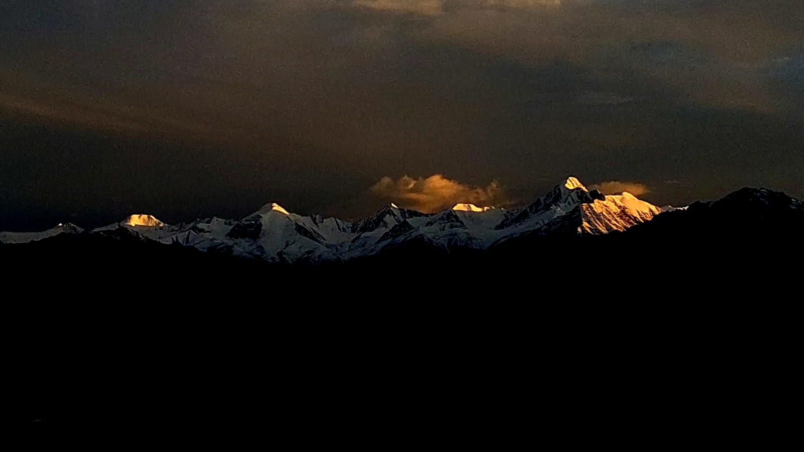 Snow peaks catching the last golden light